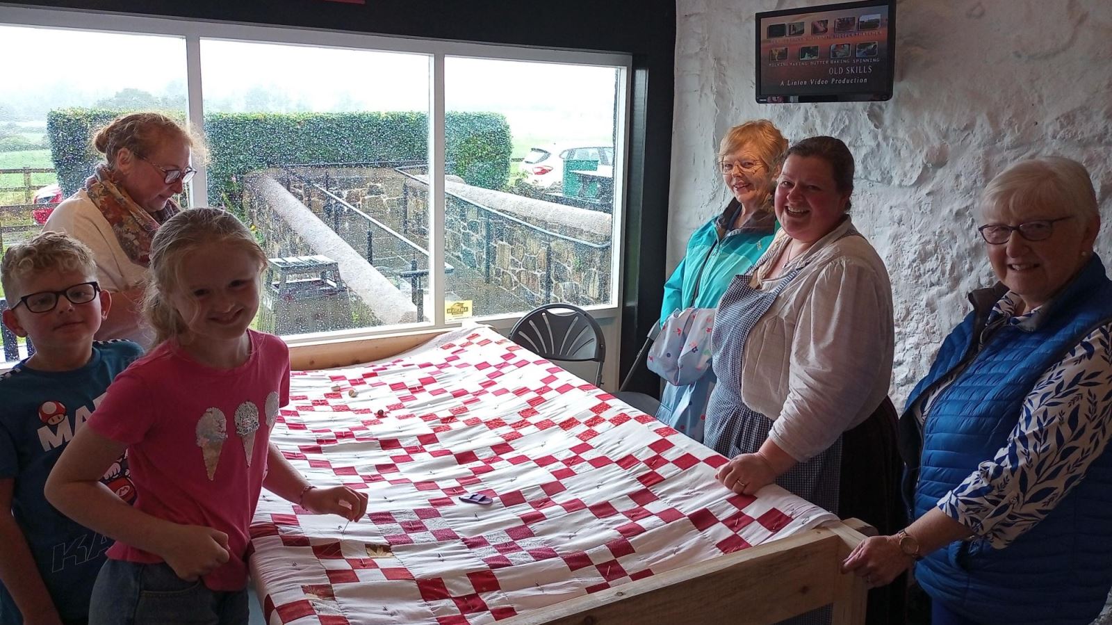 People standing round the quilting table